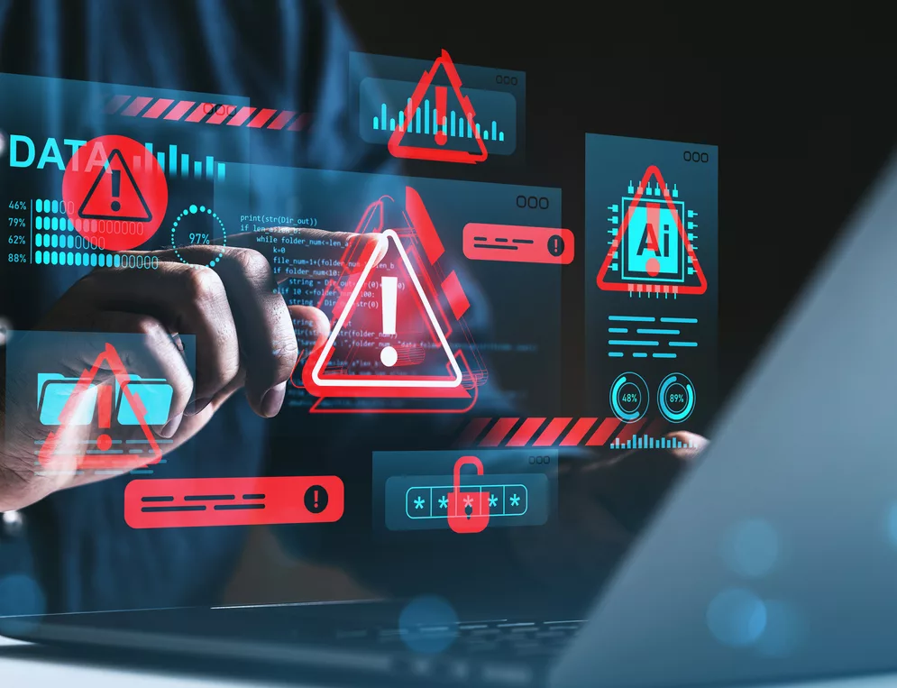 A technician reviewing security alerts and threat indicators over a laptop